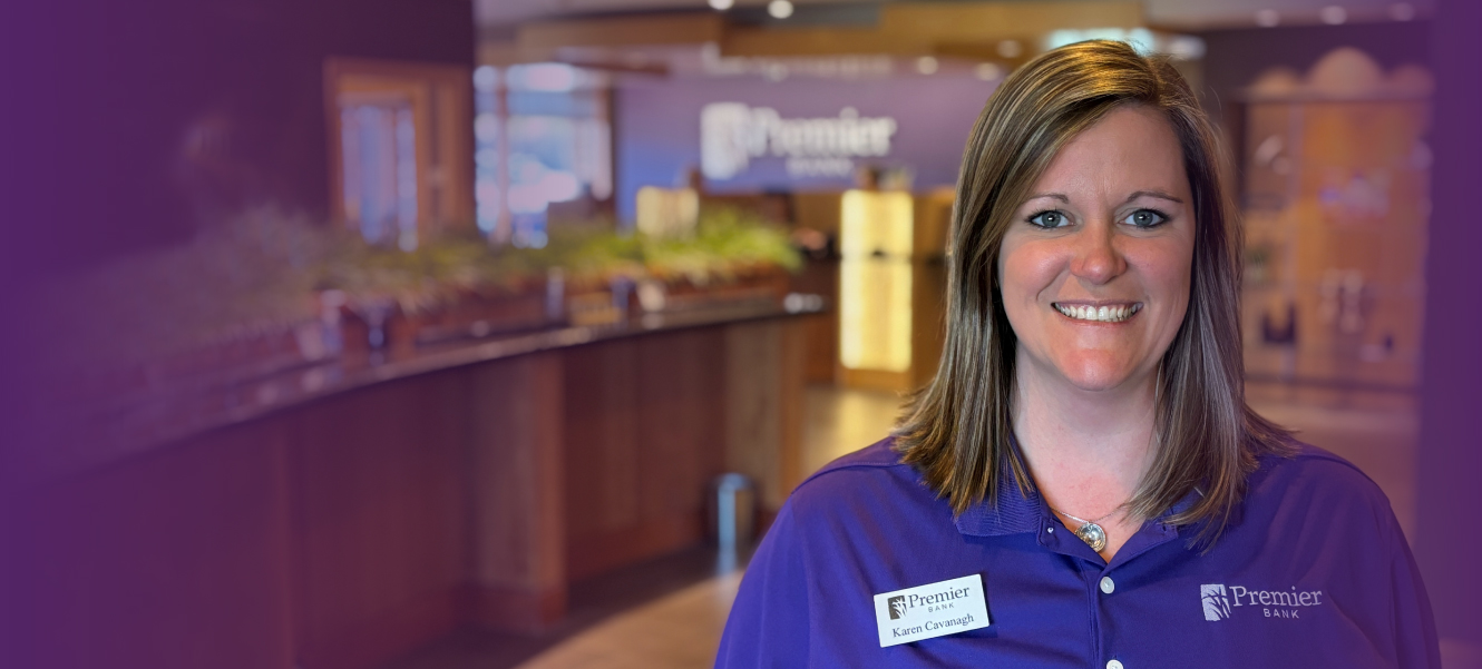 Karen Cavanagh standing in branch smiling and ready to help.